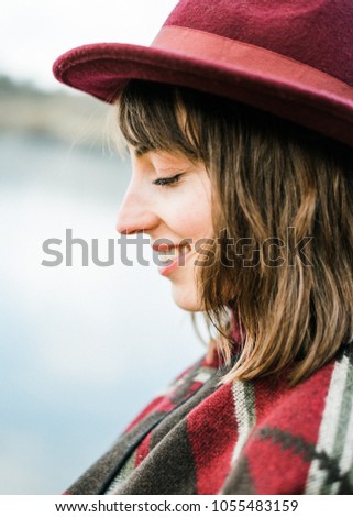 Portrait picture of a young woman enjoying her freedom. Solo traveling or enjoying nature nearby.