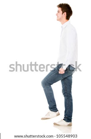 Man climbing imaginary stairs - isolated over a white background Royalty-Free Stock Photo #105548903