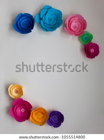 Handmade paper flowers, cut and colorful, for wedding invitation on isolated background.