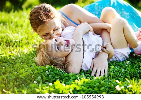 Happy woman with kid outdoors