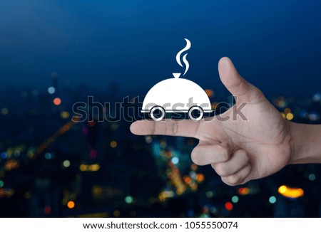 Restaurant cloche flat icon on finger over blur colorful night light city tower, Food delivery concept