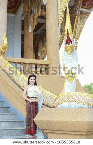 A beautiful young woman wearing Ayutthaya period, the old capital of Thailand with Naga.