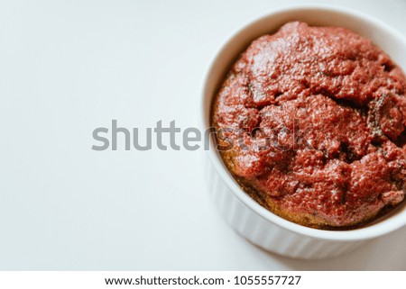 Healthy vegan beetroot muffin in white cup on white background. Festive composition, copy space available. Flat lay. Film effect.