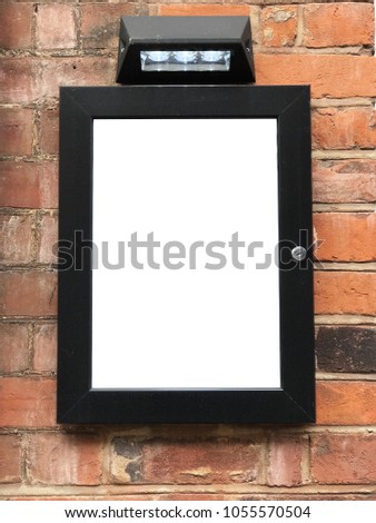 modern metal box Display with light on a brick wall Blank ad space