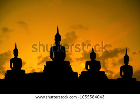 Silhouette of Big buddha statue and blurred sunset sky background on art of religion concept
