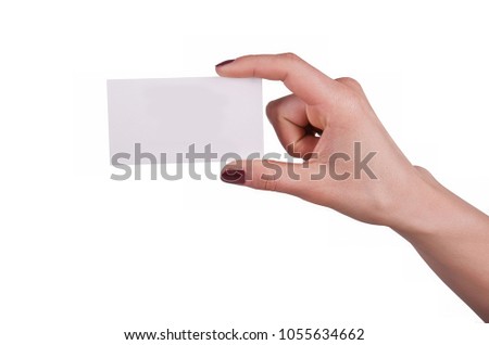 Well-groomed female hand with manicure and red lacquer holding an empty white card, isolated on white background