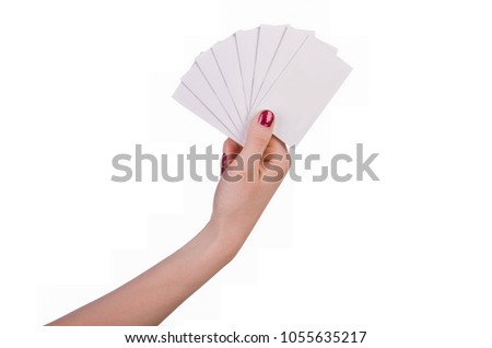 Well-groomed female hand with manicure and red lacquer holding an empty white card, isolated on white background