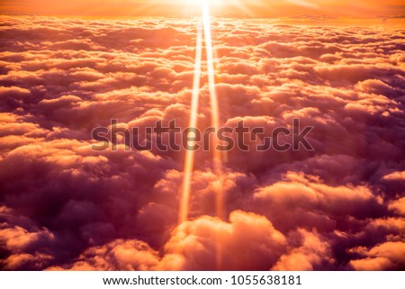 Beautiful orange sunset over the clouds. Dreamy photo, edit space.