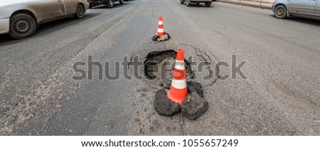 Deep hole in asphalt road.
