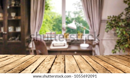 Desk of free space and blurred background of window and home interior. 