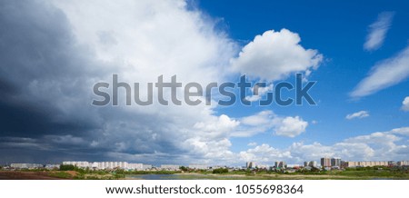 Naberezhnye Chelny cityscape under blue sky with scenic fluffy clouds.