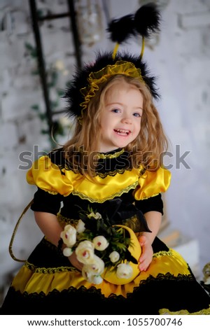 little girl dressed in bee's clothes.little girl dressed in honey clothes