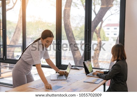 Business woman working in office with hand pointing documents.Teamwork successful concept.