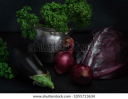 Still life of raw vegetables on a dark background