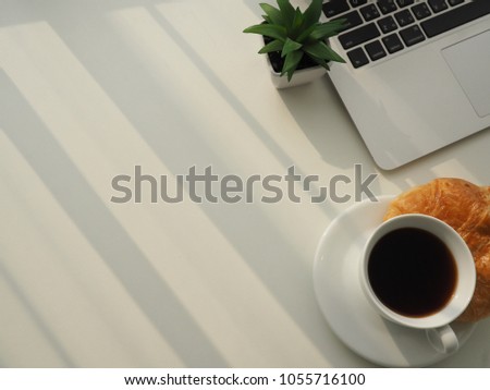 Coffee cup and fresh baked croissants on whrite background. Top View.