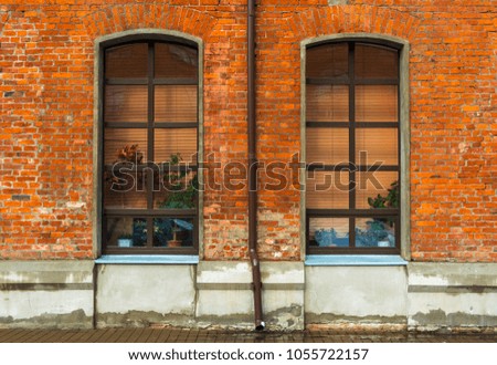 Two tall Windows in a brick wall