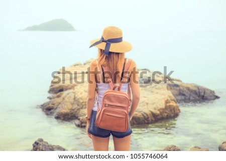 rear view of an attractive women looking at clear water sea in day . Thailand , Asia