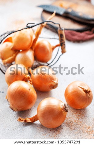  fresh raw onions in a basket, stock photo