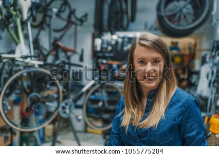 Female Bicycle Mechanic. Female technician in her bicycle repair shop. Portrait of young female mechanic in bicycle store