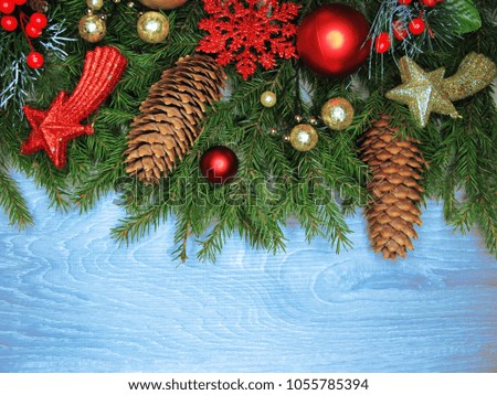 christmas background and cones decoration with fir branches on wooden board