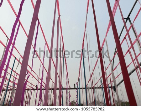 Various colored ropes have sky as background.