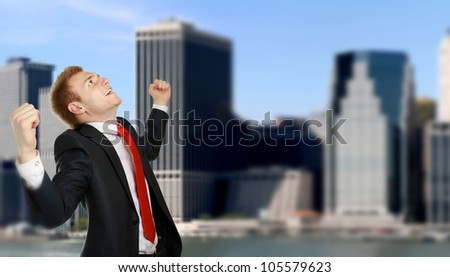 Happy businessman standing  over a cityscape