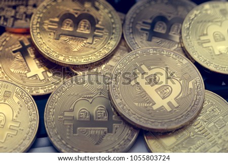 Bitcoin coins on a computer keyboard. Virtual currency with shallow depth of field on the laptop.