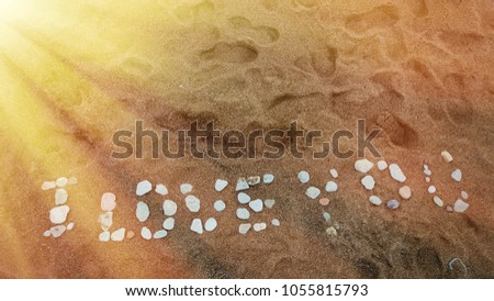 I love you words made from stones on the sand.