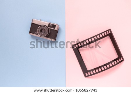 Retro film camera and photo frame isolated on colorful pastel background minimal creative concept.