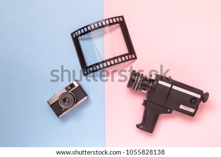 Retro vintage analog film camcorder, photo camera and picture frame on pastel background minimal technology creative concept.