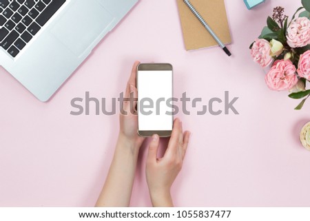 Top view of mockup of laptop, mobile phone with white copy space screen in woman hand. Flat lay of workspace