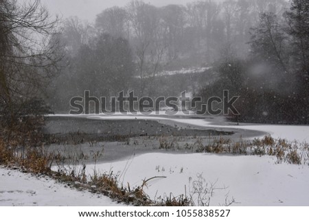 A part frozen lake on a winters day