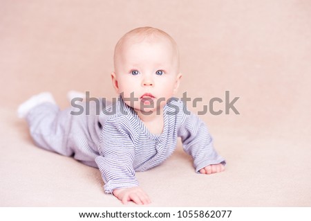 Funny baby boy 1-2 month old lying in bed close up. Good morning. Childhood. 