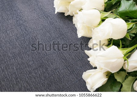 Beautiful white roses on rustic wooden background with copy space. Wedding or Valentine day decorative backdrop.
