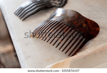 Old combs on a white marble table