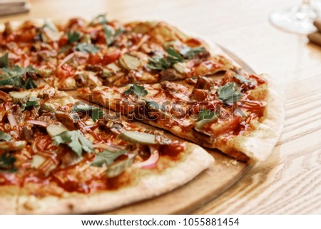 Meat pizza with hot barbecue sauce and pickled cucumbers, toned picture