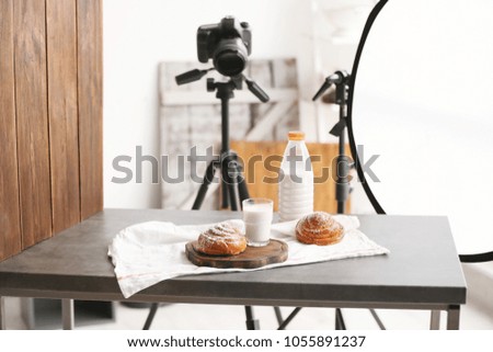 Professional camera on tripod and food composition in photo studio