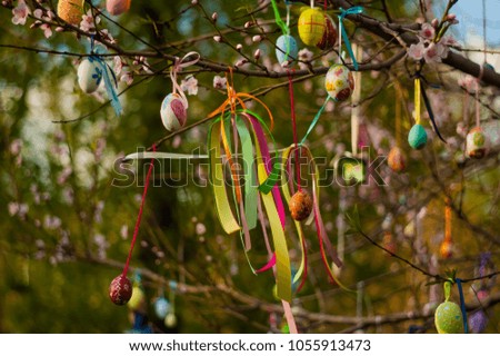 Painted eggs hanging on the branches of trees