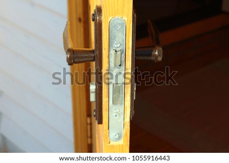 Internal door lock in the wooden door. Close-up.