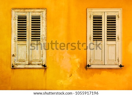 Yellow wall with two windows with shutters in Plaka district in Athens, Greece                  