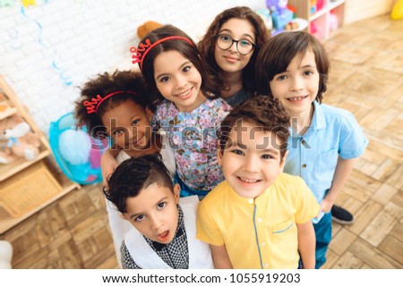 Portrait of joyful children in holiday hats at birthday party. Happy birthday party. Little children on birthday celebrations.