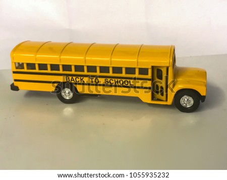 Toy school bus with black signage on a side.