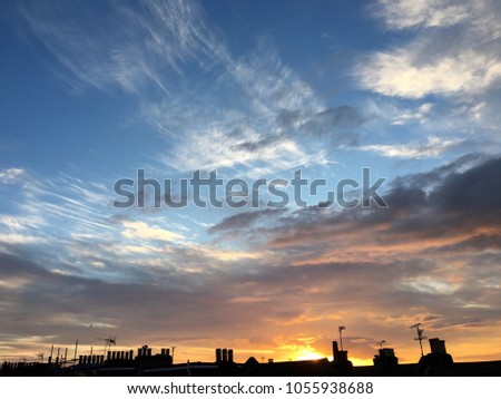 Beautiful sunset sky over silhouette of a city. Colourful sky and cloud formations. Nature natural landscape outdoor scenery 
