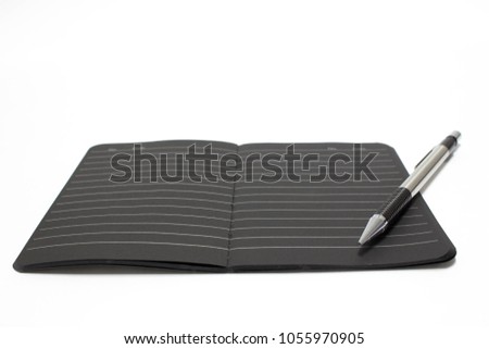 black Notebook  and pen isolation white blackground blur