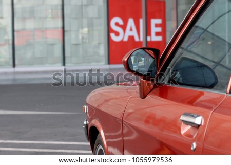Side view of old red car and sale label, copy space, transportation background, car shop