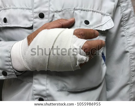 Male worker who injured his hand during work. Royalty-Free Stock Photo #1055986955