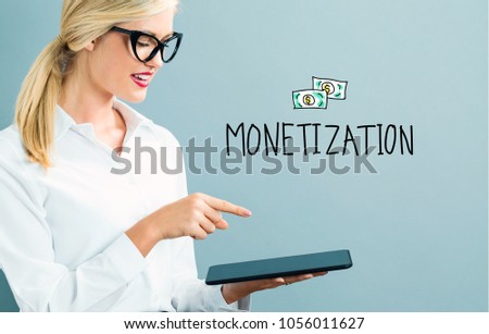 Monetization text with business woman using a tablet