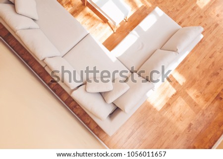 White sectional couch in a large luxury interior home Royalty-Free Stock Photo #1056011657