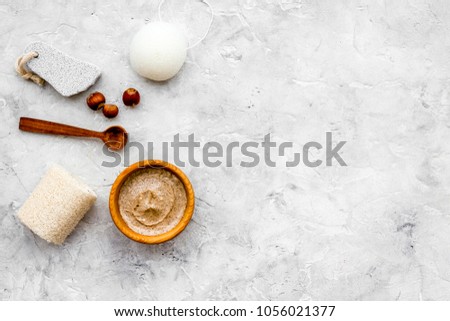 Homemade spa with organic scrub and hazelnut on stone background top view space for text