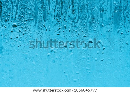 Texture of small water drops on transparent glass. High humidity and condensation